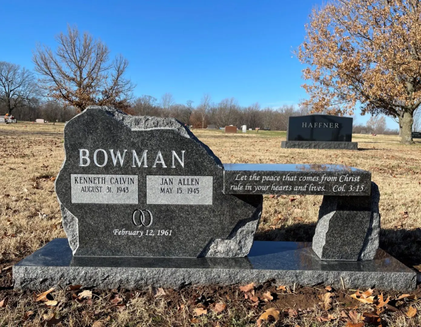 A bench with two headstones in the background.