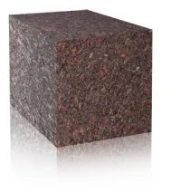 A block of brown marble sitting on top of a white surface.