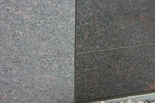 A close up of two different granite tiles