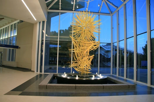 A large glass sculpture of a yellow flower.