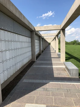 A long walkway with many windows and benches