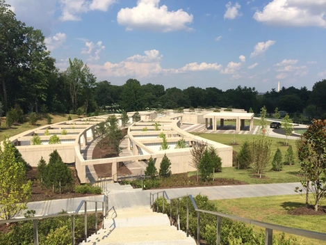 A view of the top of stairs leading to a park.