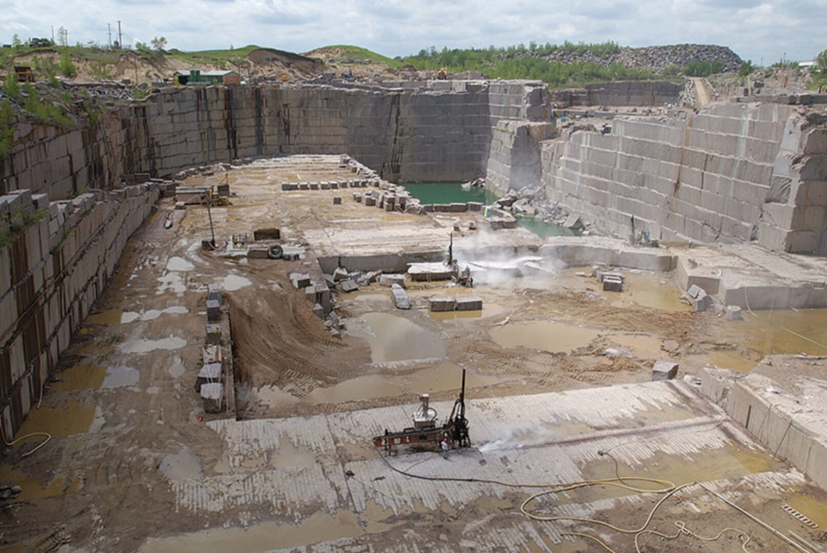 A large open pit with lots of rocks and dirt.