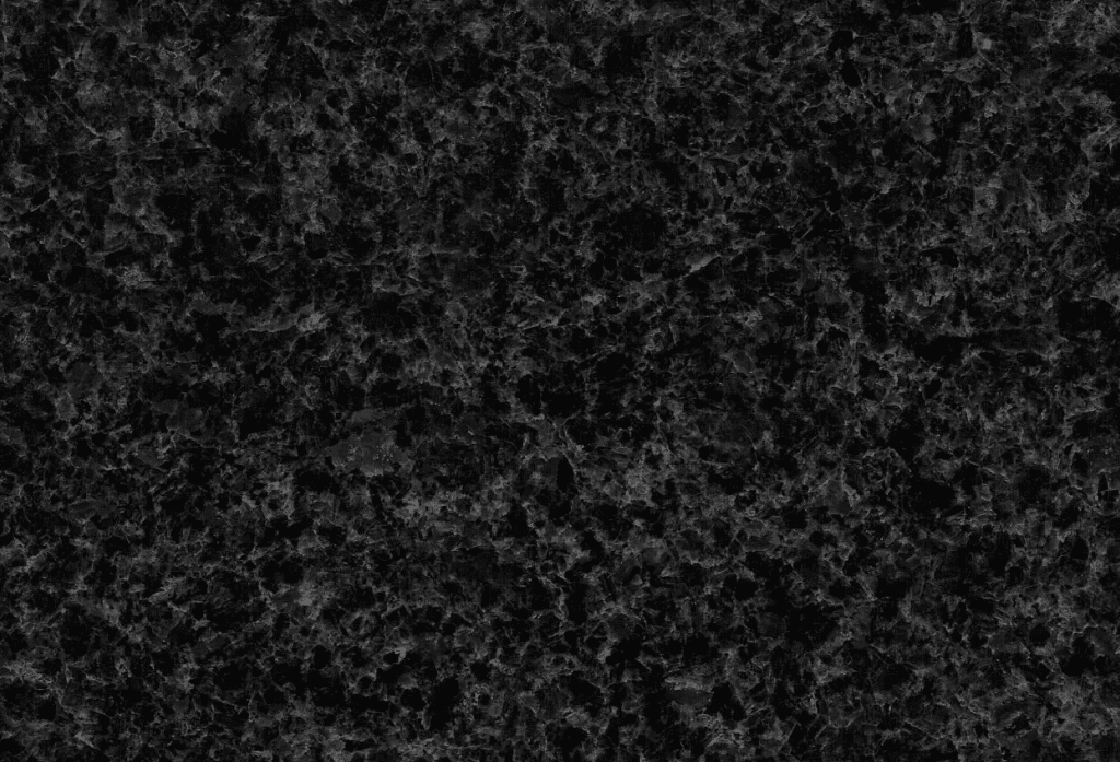 A black granite stone surface with some small spots.
