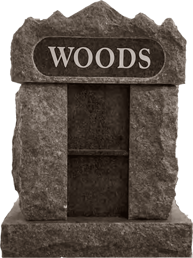 A stone grave marker with the word woods on it.