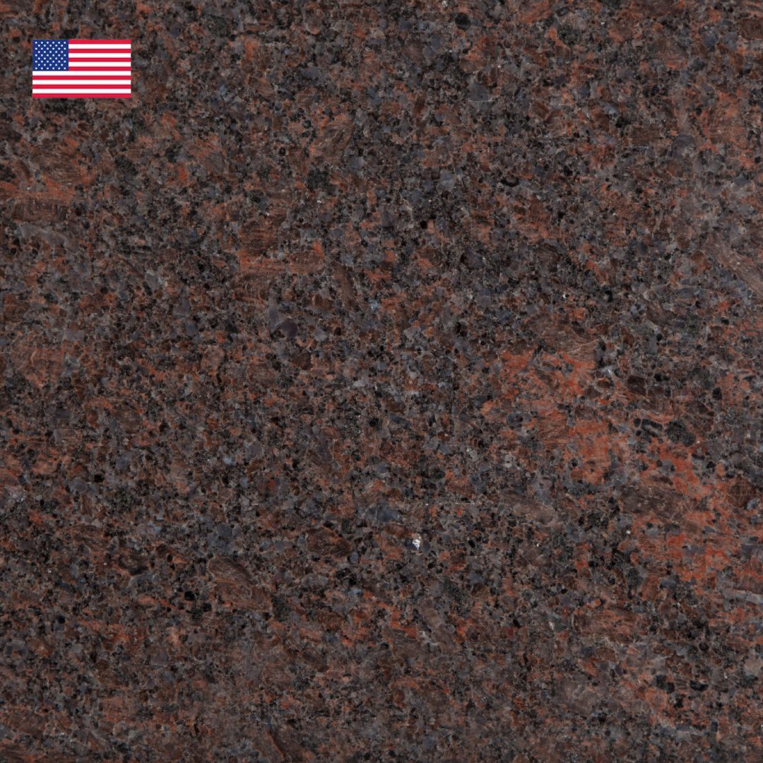 A close up of the american flag on a granite slab